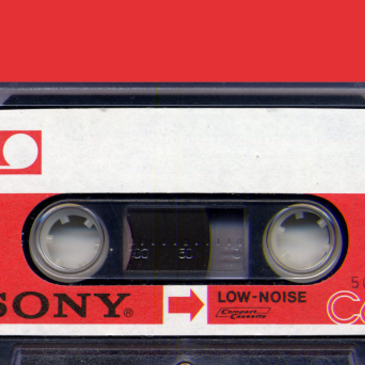 A close-up of a Sony Cassettes Compact Cassette tape, showing the red, white, and black plastic casing with the brand name 'SONY' and 'LOW-NOISE' printed on the label.
