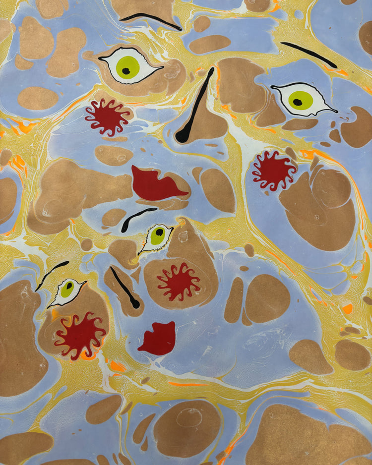 Abstract artwork featuring a marbled pattern of light blue, gold, and brown, with stylized green and yellow eyes and red splatter motifs.